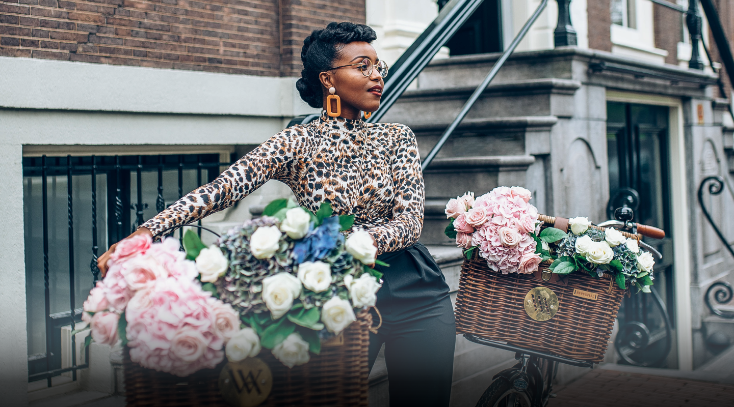 Female standing at a rail looking at the ocean